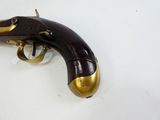 a gun that is sitting on a white surface