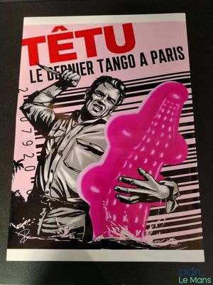 a close up of a poster on a table with a person holding a pink object