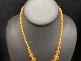 a close up of a necklace on a mannequin display