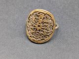 a close up of a gold ring on a gray surface