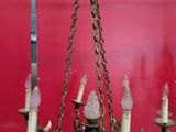 a chandelier with five candles hanging from it