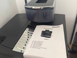 a printer sitting on top of a desk next to a printer