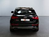 the rear end of a black audi suv parked in a showroom