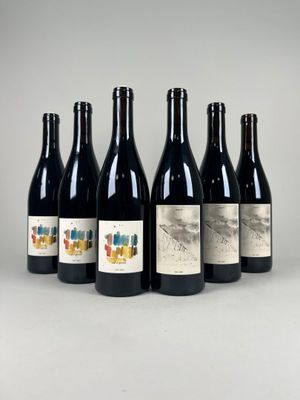 six bottles of wine are lined up in a row