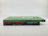 two books are stacked on top of each other on a table