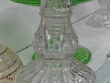 many glass items on a table with a white table cloth