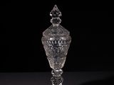 a clear glass vase sitting on top of a black table