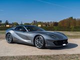 the silver sports car is parked on the side of the road