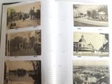 an open book with pictures of a town and a river