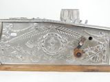 a silver metal box with a lock on a wooden stand