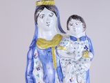 a figurine of a woman holding a child