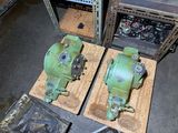 two green machines sitting on top of a table