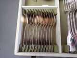 a drawer with a bunch of forks and spoons in it