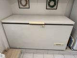 an image of a white refrigerator in a small room
