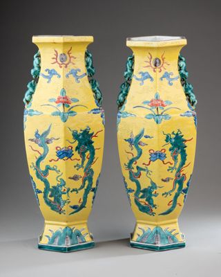 pair of yellow vases with blue and green designs on them