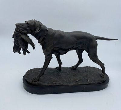 bronze statue of a dog with a duck in its mouth