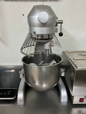 un mixeur argenté posé sur le plan de travail d'une cuisine