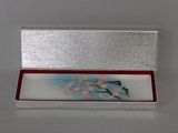 a silver box with a picture of a bird on it