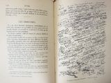 an open book with writing on it sitting on top of a table
