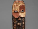 a wooden mask with a face and two eyes