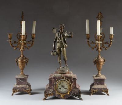 a statue of a man holding a flute next to three candelabs