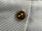 a close up of a button on a white shirt