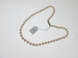 un gros plan d'un collier de perles muni d'une étiquette