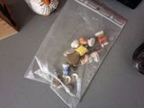 a plastic bag with a bunch of small figurines inside of it