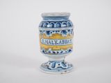 a small blue and white vase with a yellow label on it