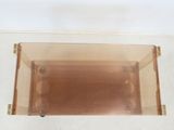 a clear box with a brown lid on a white surface