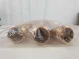 four rolls of doughnuts wrapped in plastic on a table