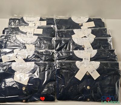 a lot of blue shirts that are wrapped in plastic