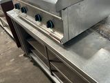 stainless steel counter top with three burners and two burners on it
