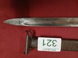 a very old knife that is laying on a table