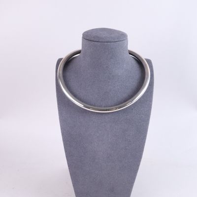 grey display case with a silver ring on top of it