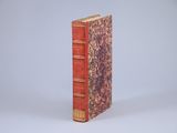 a red book that is sitting on a white surface