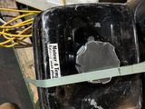 a black box with a green tape on top of it