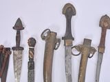 five different types of knives on display on a white surface