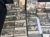 a lot of old black and white pictures on the table