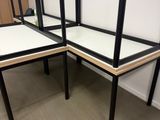 two desks that are sitting in the corner of a room