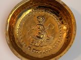 a gold plate with a picture of a person on it