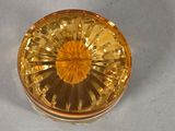 a yellow glass container with a yellow flower inside of it