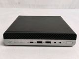 the back view of a black and silver laptop computer on a white surface