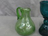 two glass vases sitting next to each other on a table