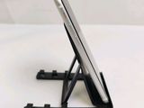 a cell phone sitting on a stand on a table