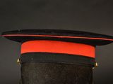 an image of a black hat with a red stripe on it