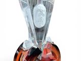 sculpture of a face on a glass block with a wooden base