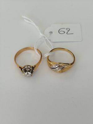 two gold rings with diamonds and a price tag