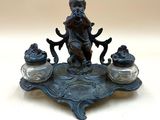 a statue of a boy sitting on top of a table