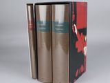 three books are stacked on top of each other on a table